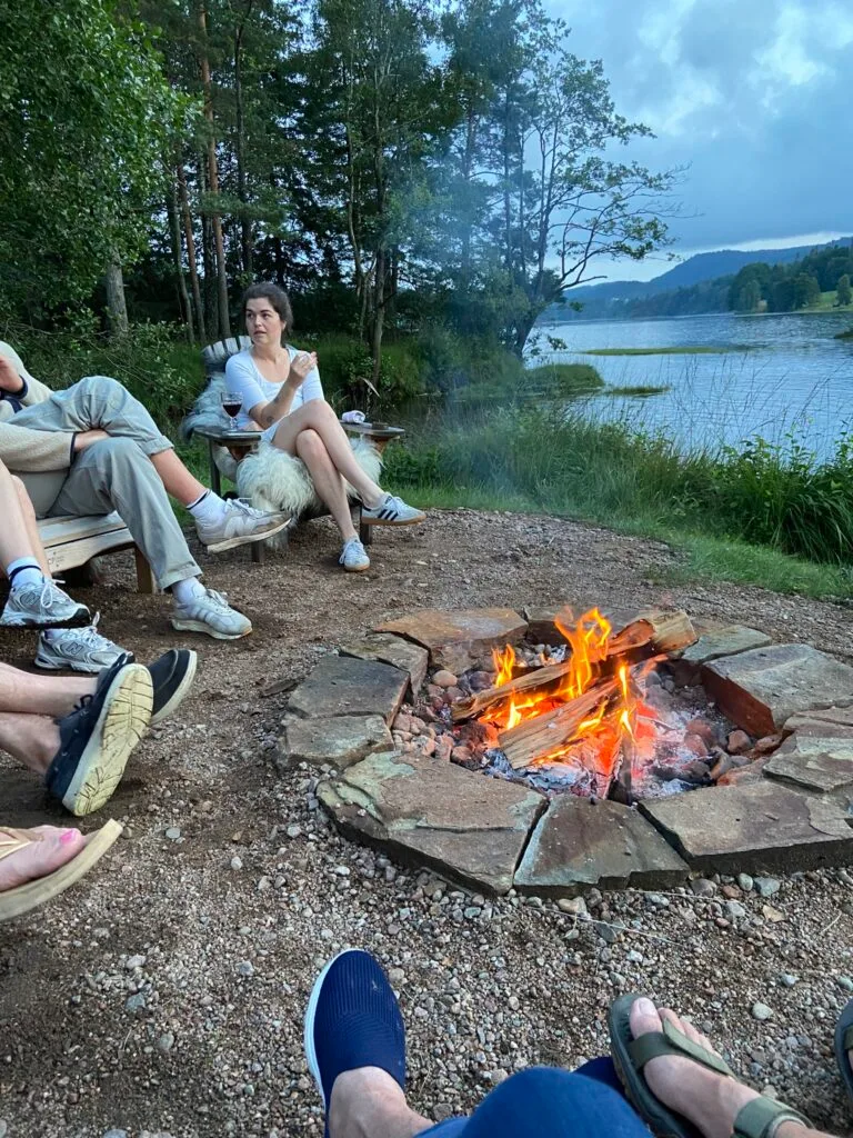 Gathering by the waterside fire pit