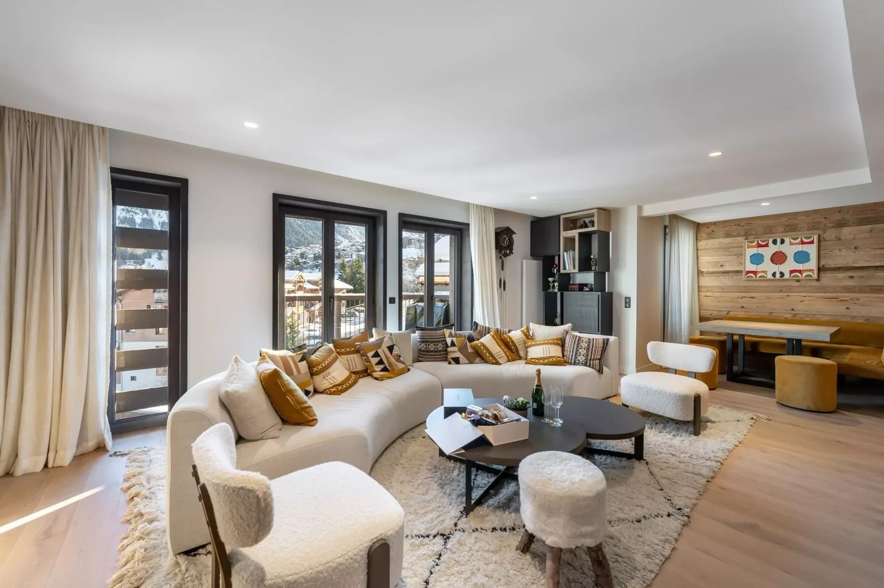 A bright living room with seating arranged around a low coffee table.
