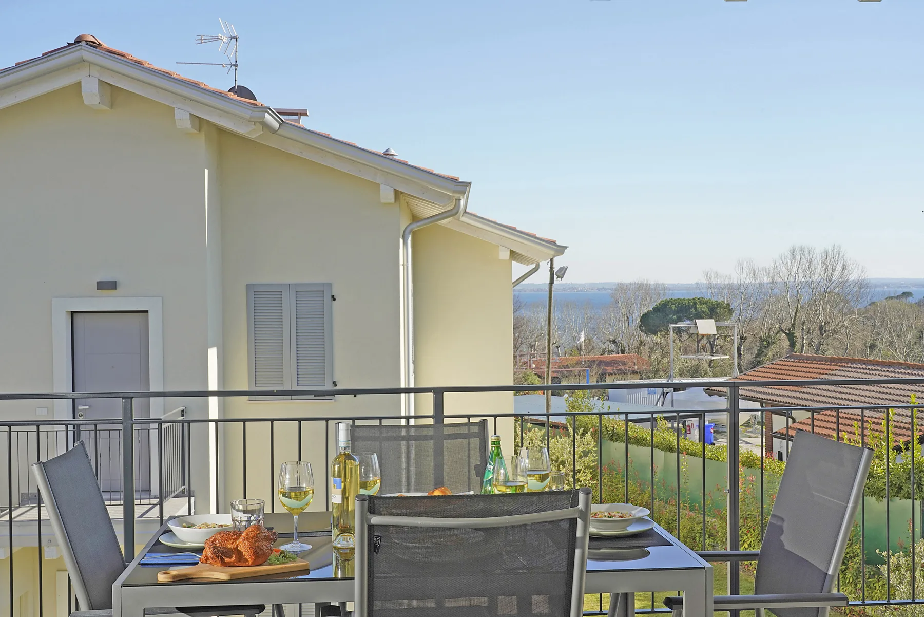 Outdoor dining area on a terrace overlooking the sea.