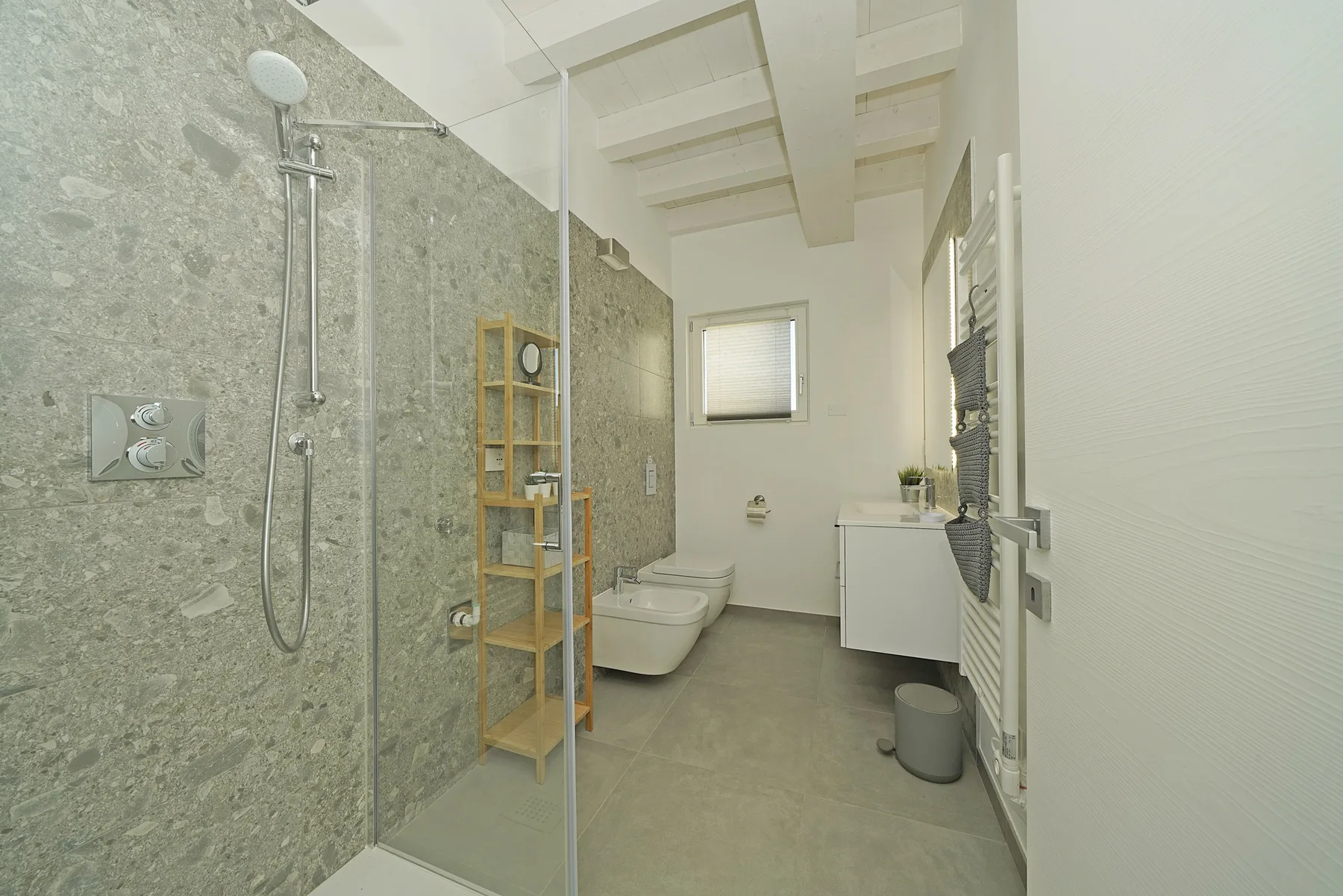 A bathroom with a walk-in shower, toilet, and vanity.