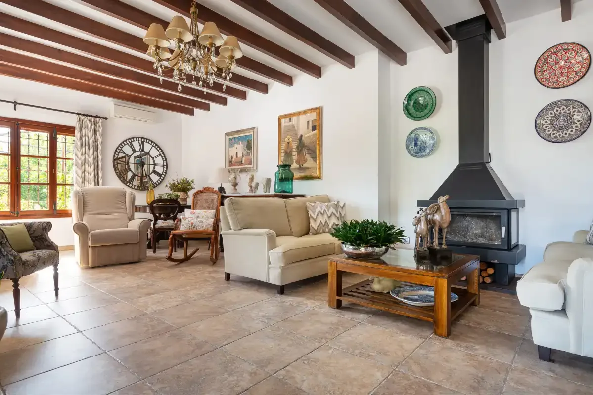 A living room with seating, a coffee table, and a fireplace.