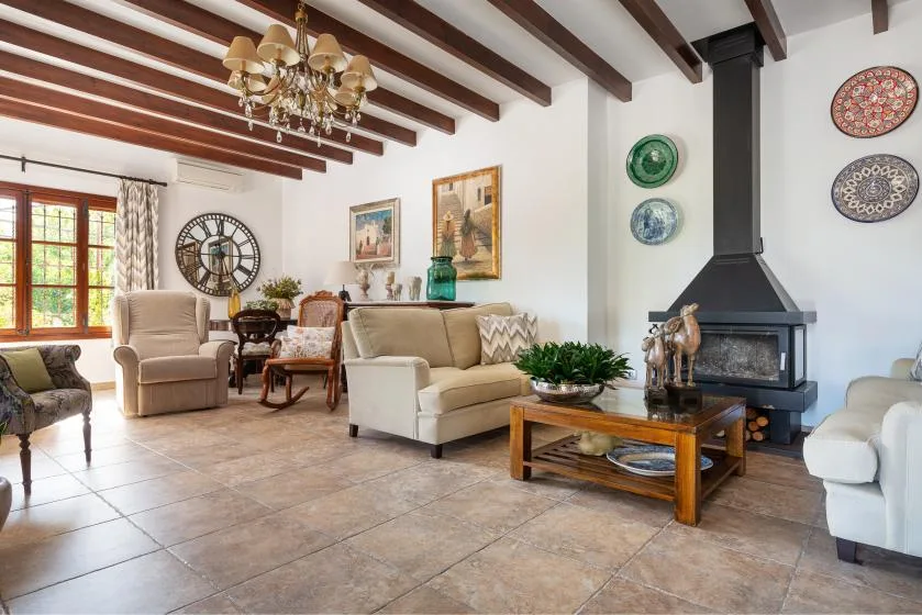 A living room with seating around a coffee table and a fireplace.