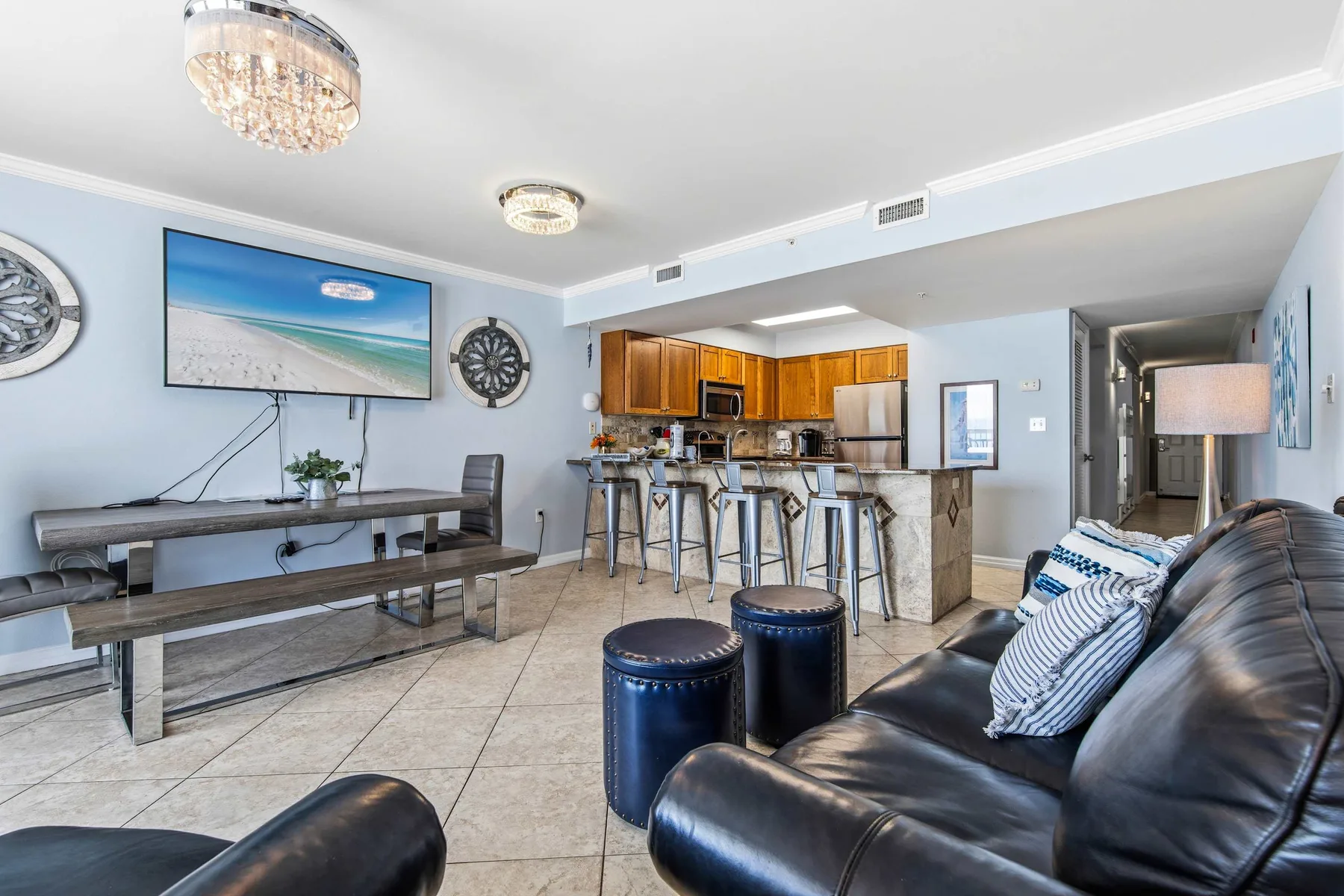 An open-plan living room and kitchen with a dining table and island seating.