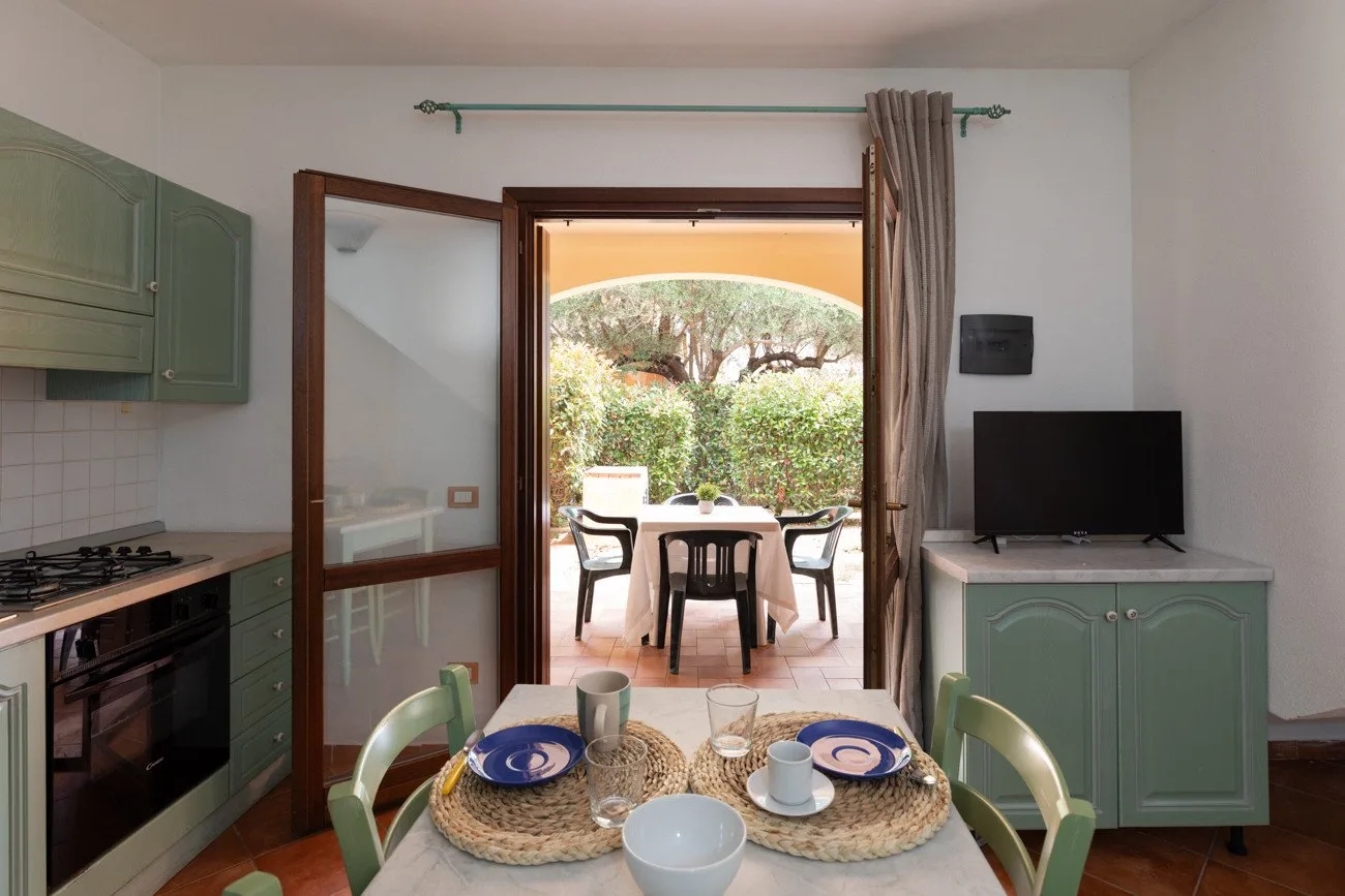 La cocina y el comedor dan a un patio con asientos al aire libre a través de puertas de vidrio.