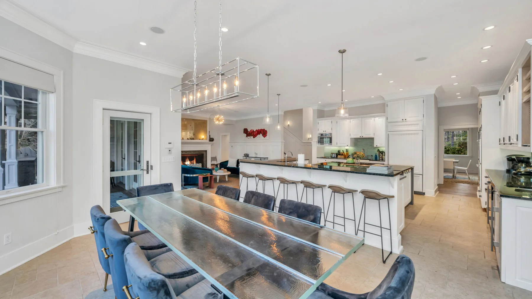 Una cocina luminosa con una isla larga y una mesa de comedor.