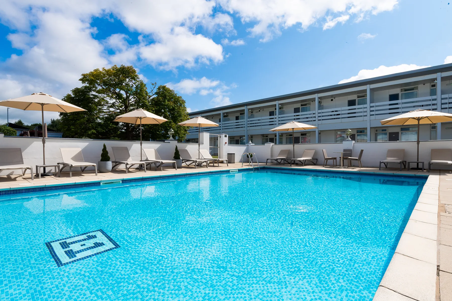 Outdoor swimming pool and loungers