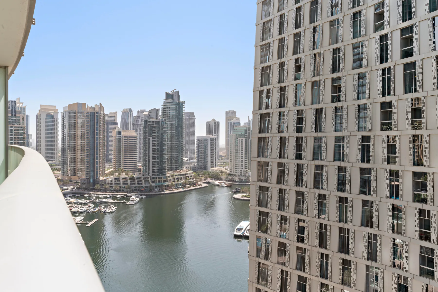 A waterfront city view shows high-rise buildings lining a marina.
