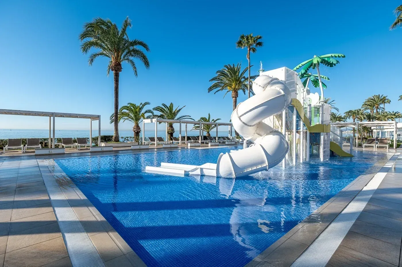 Pool with slides and palm trees