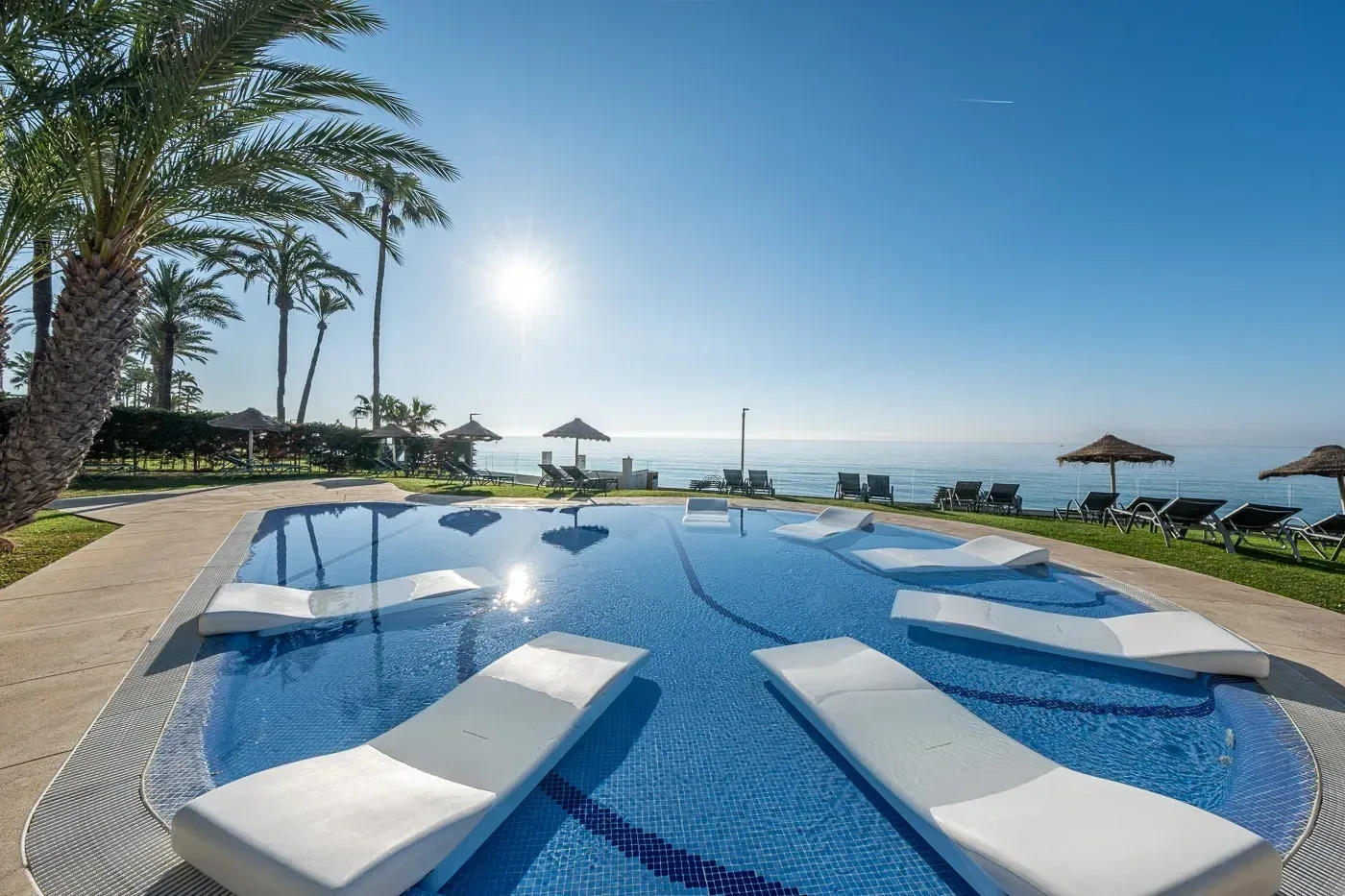 Pool with loungers and sea views