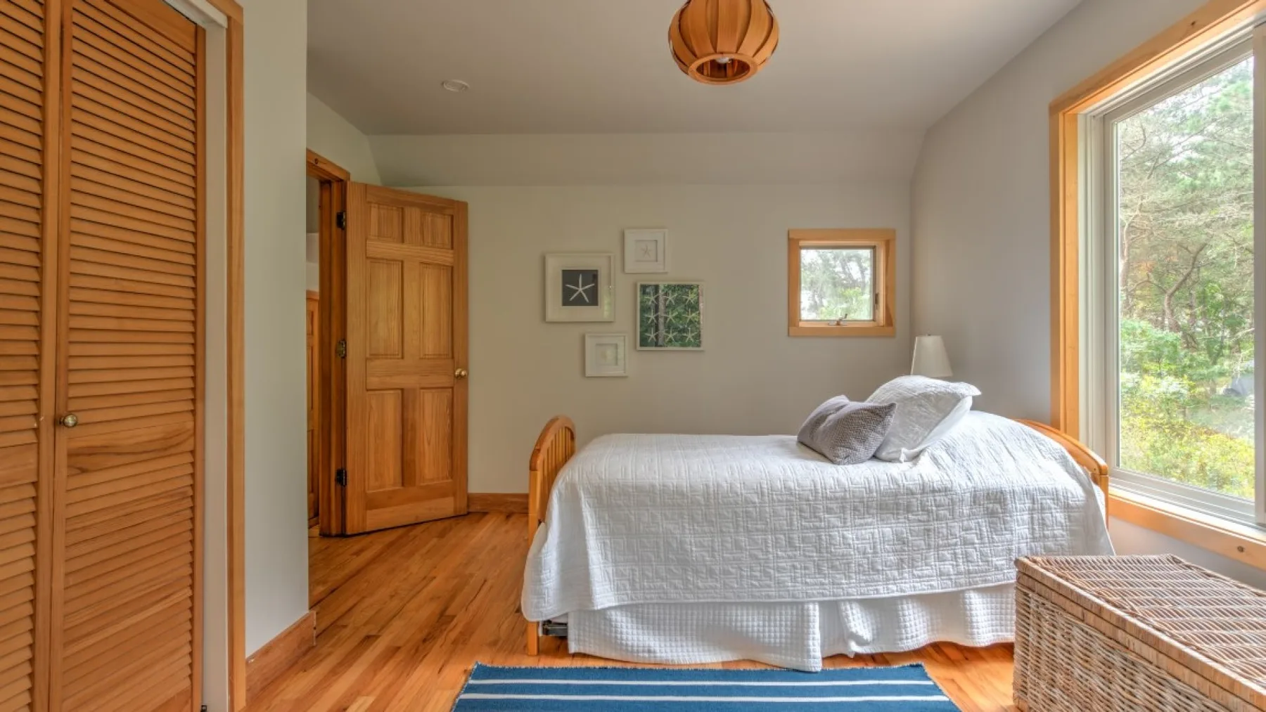 Un dormitorio con una cama junto a una ventana grande.