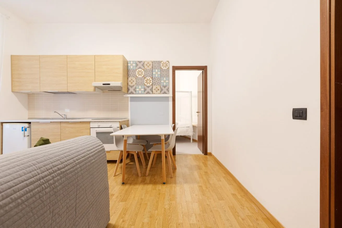 A compact kitchen and dining area with a table and seating.