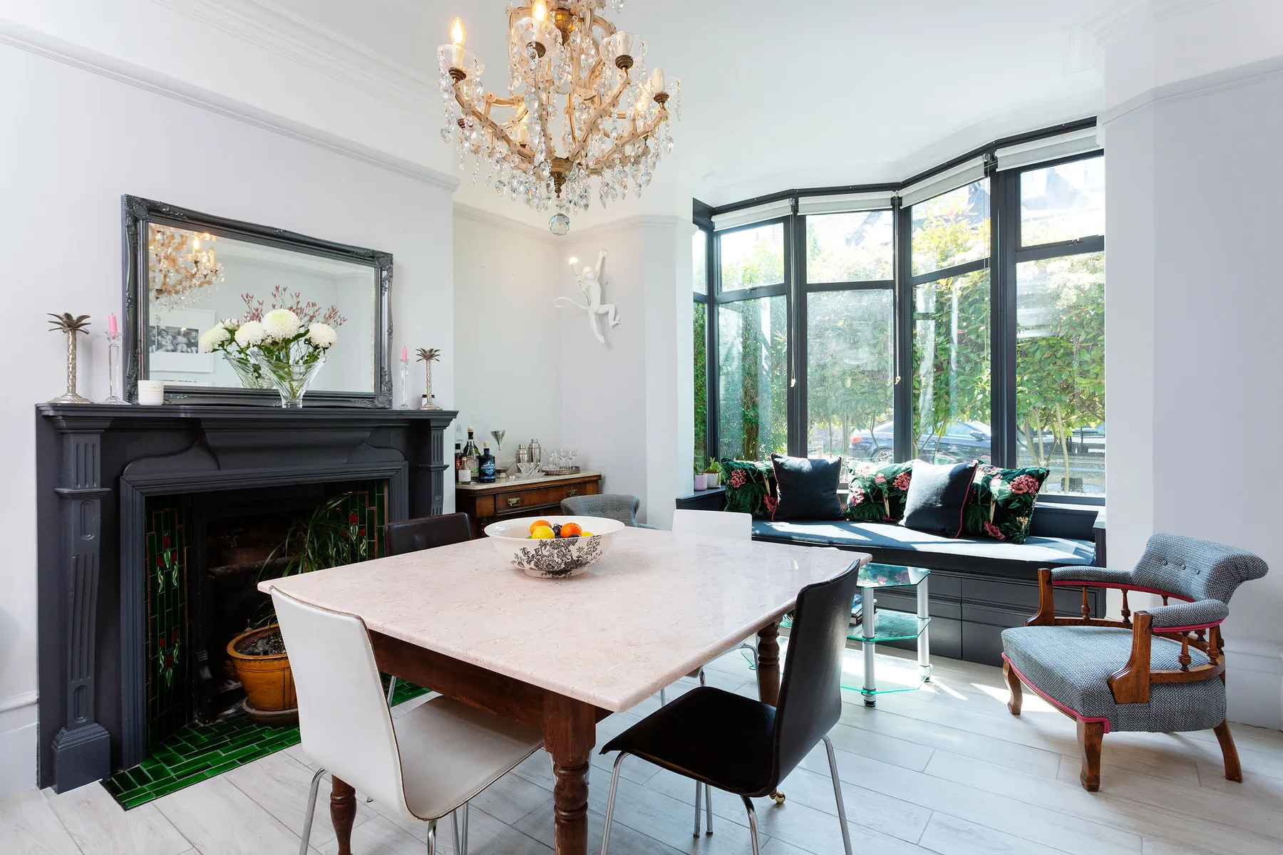 A bright dining area with a table beside a large bay window.