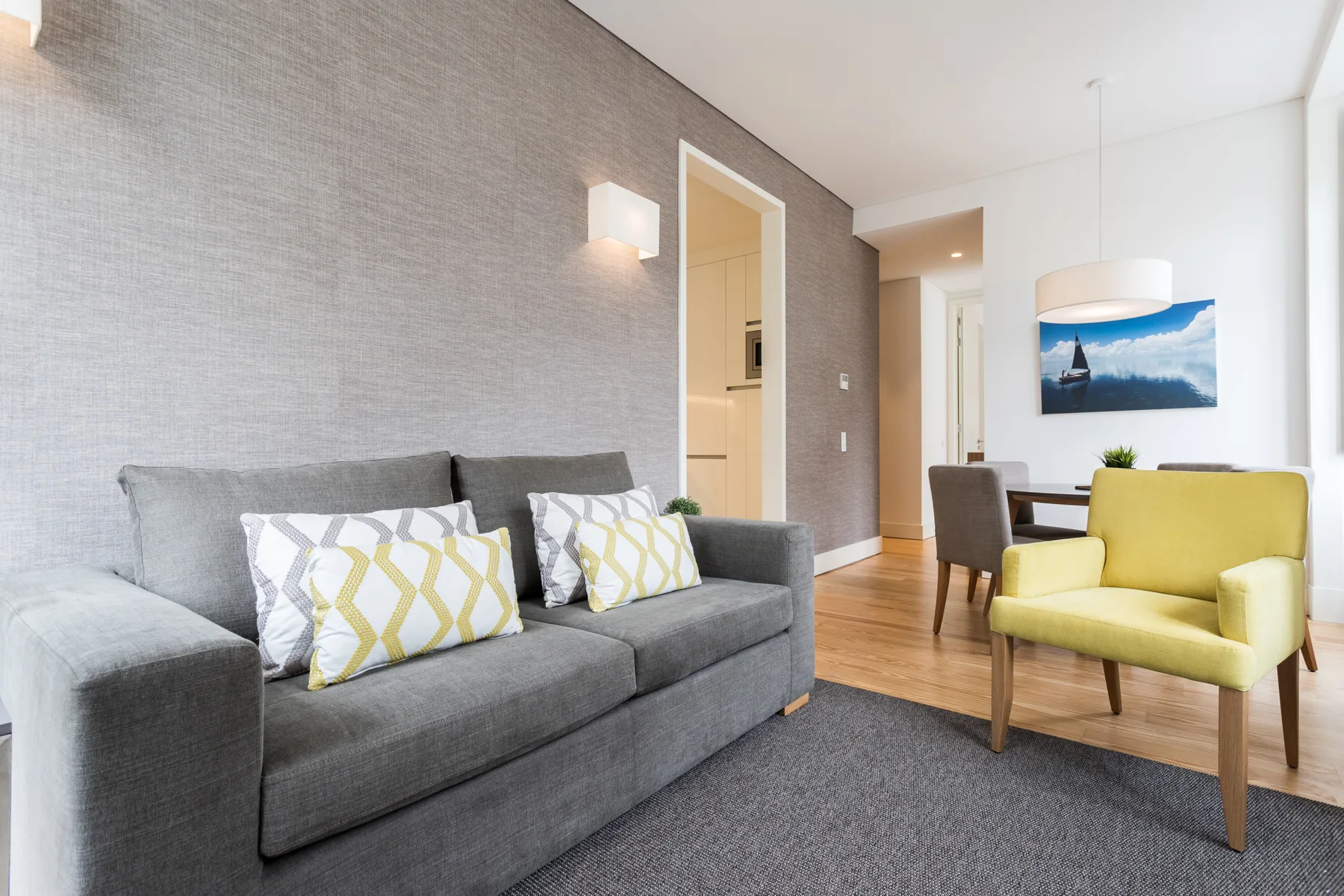 A living room with a gray sofa and a yellow armchair.