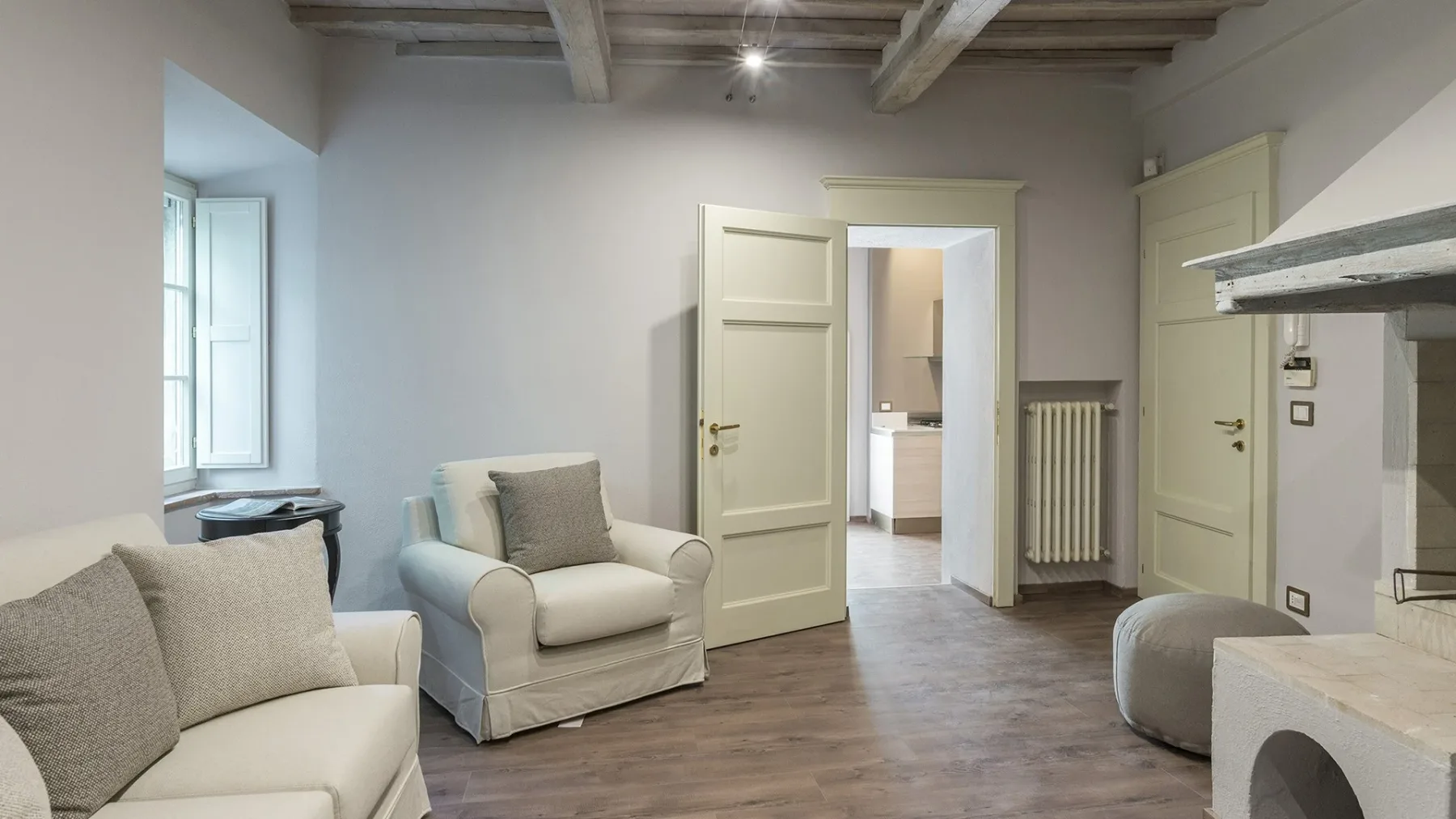 Una sala luminosa con asientos claros y puertas abiertas.
