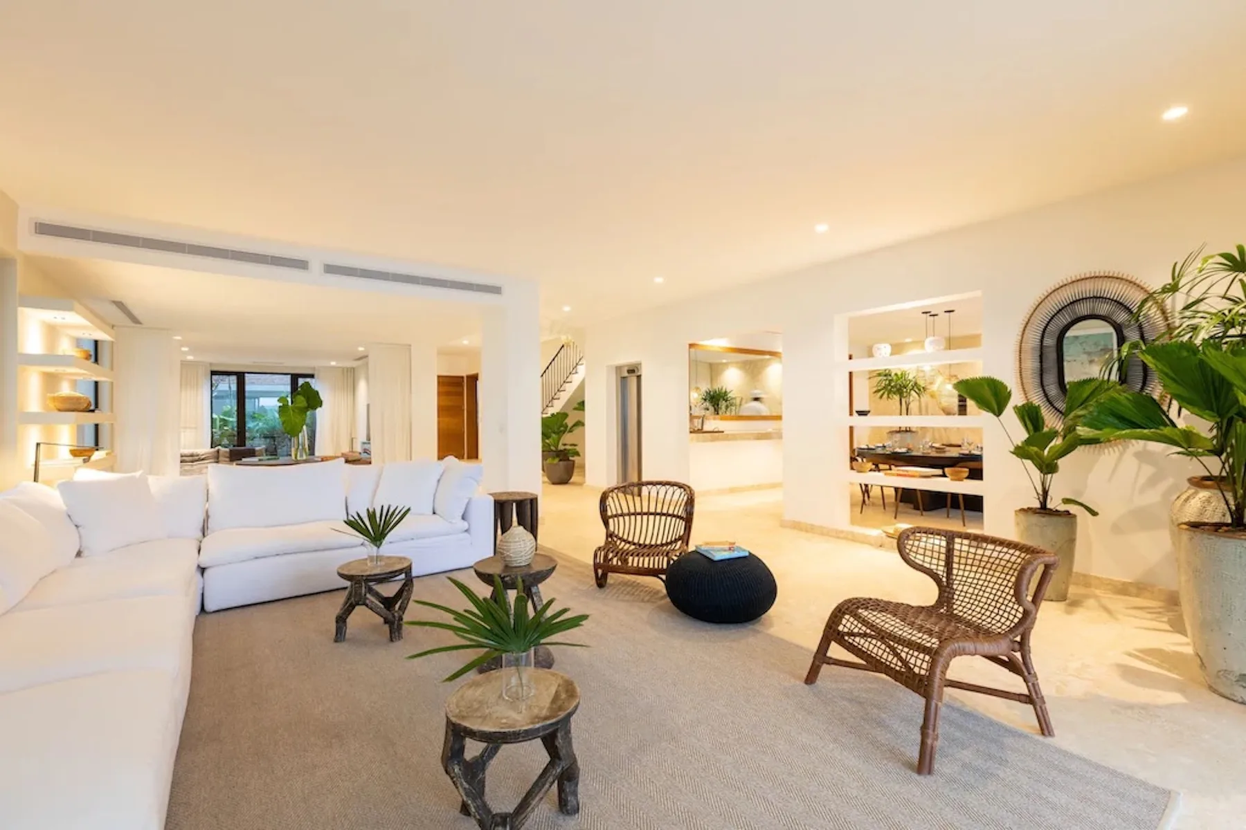 A bright living room with seating arranged around a coffee table.