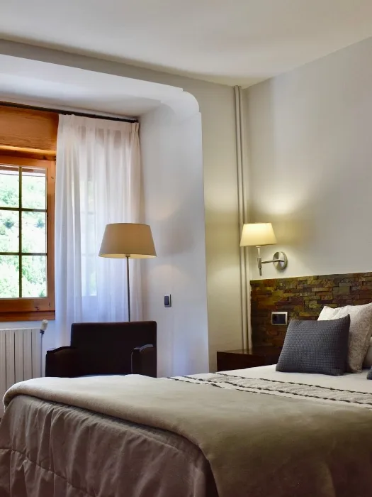 Habitación doble estándar abuhardillada con escritorio, silla, sillones y cama de matrimonio