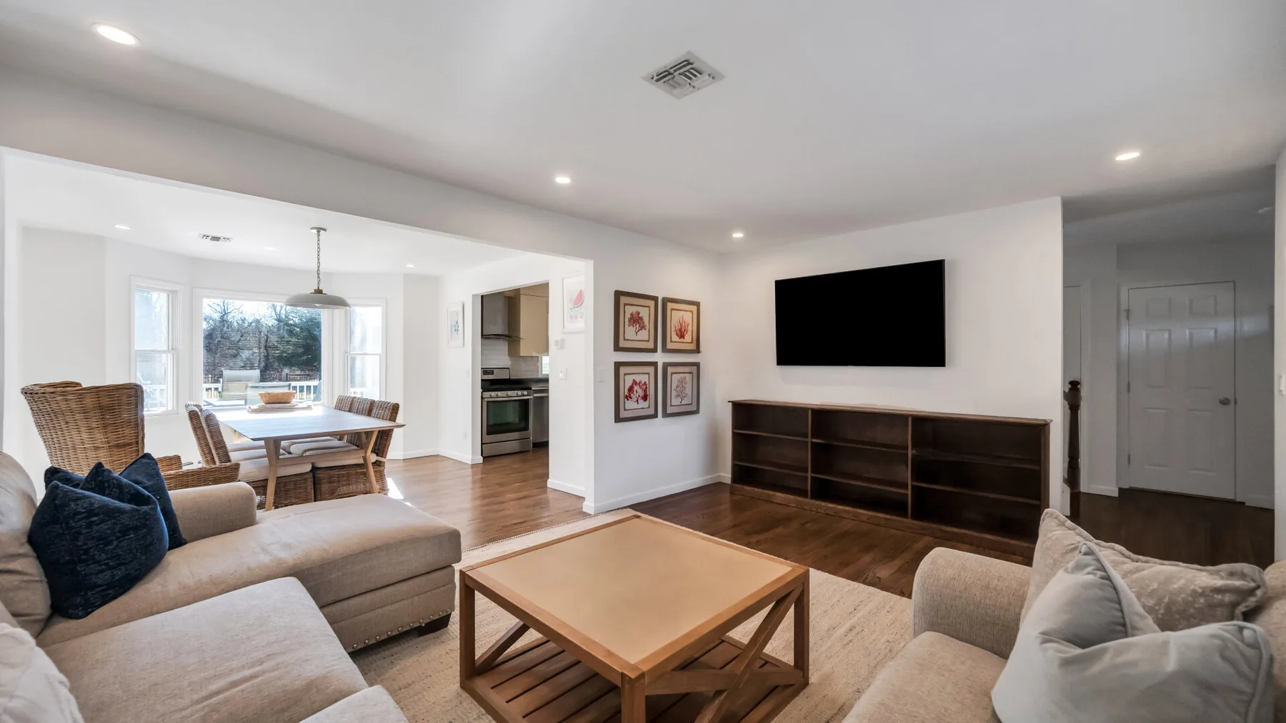 Living room with seating, a coffee table, and a television.