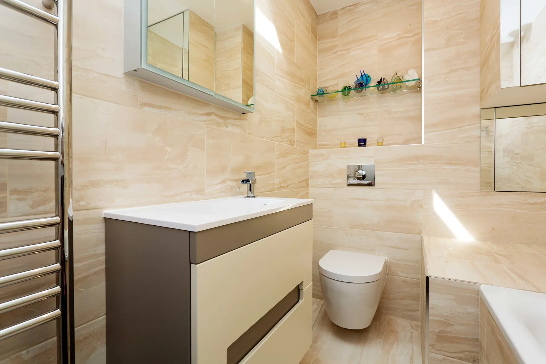 A bathroom with a vanity, toilet, and bathtub.