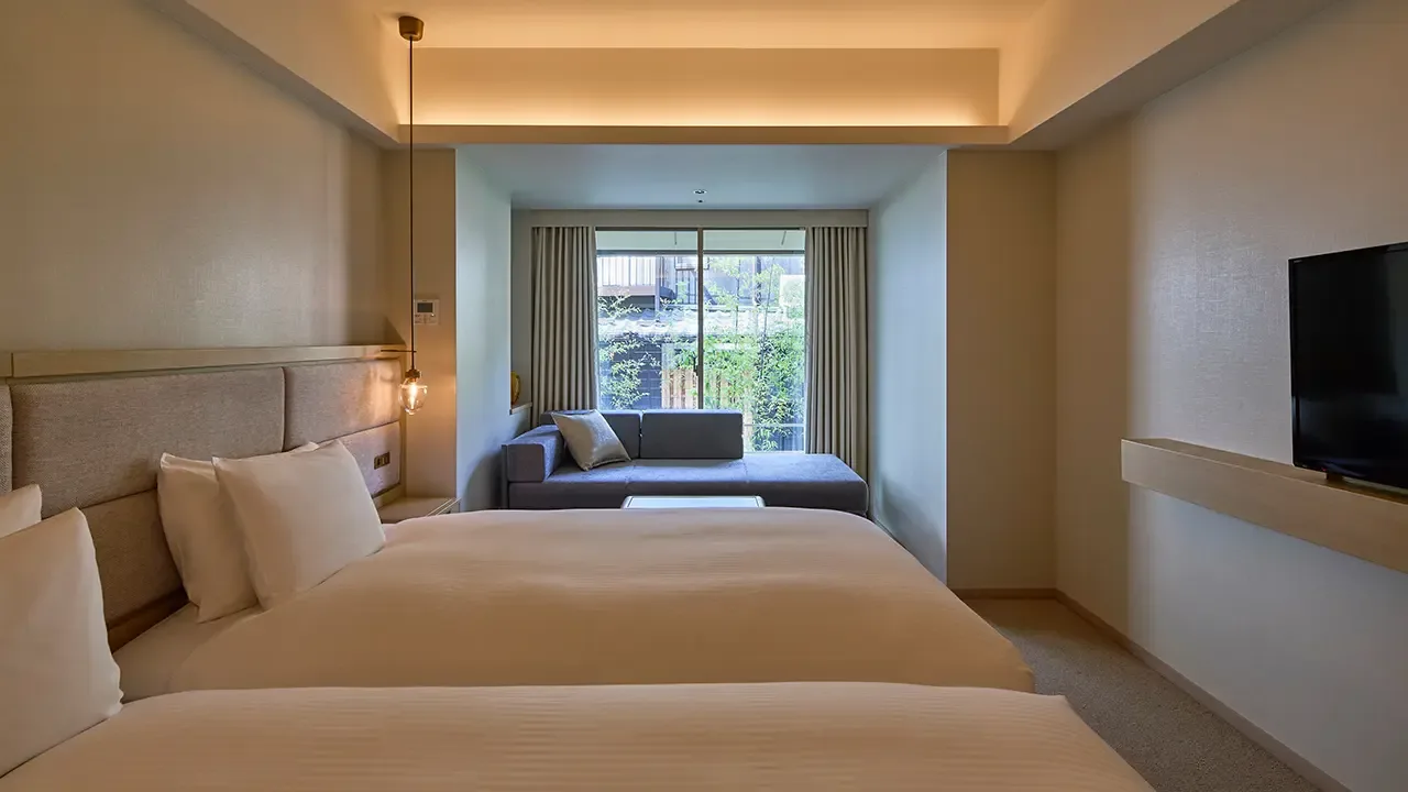 Habitación deluxe con dos camas individuales y diván