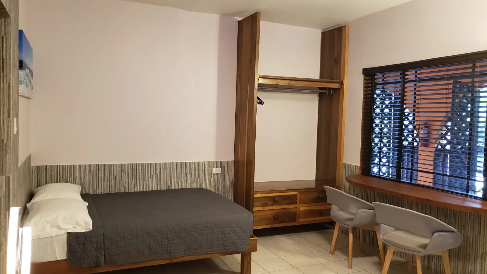 Habitación de Ocean Mist con cama, armario, sillas y ventana.