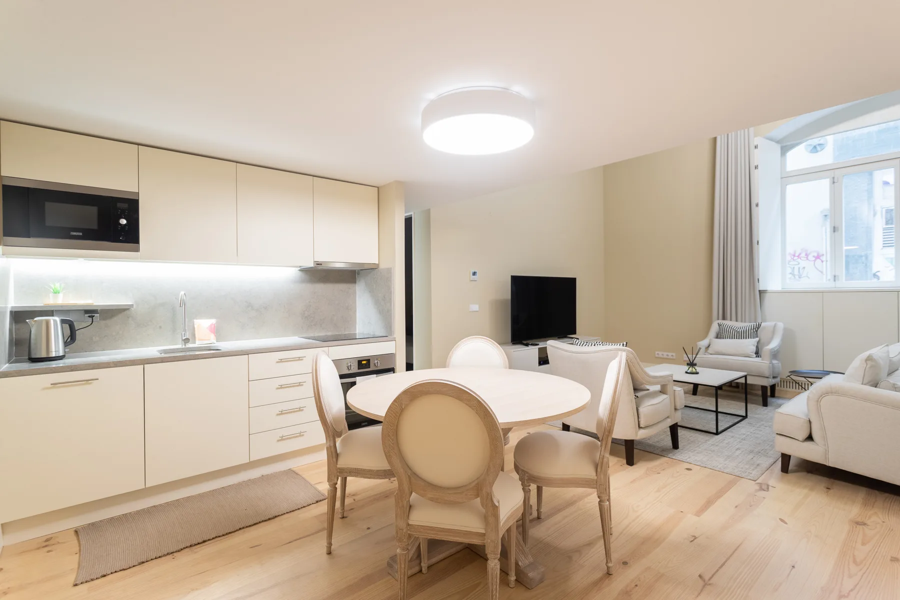 An open-plan living and dining area with a kitchen and seating.