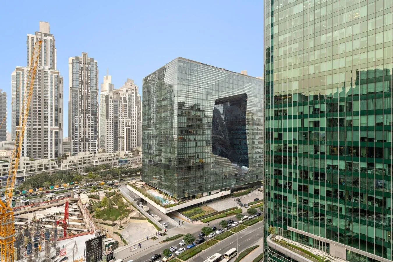 Un paisaje urbano con torres modernas de vidrio y una obra en primer plano.