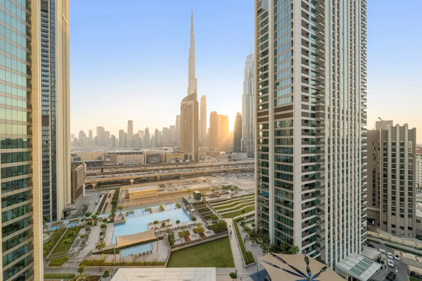 City skyline with a very tall central tower, viewed between modern high-rise buildings.