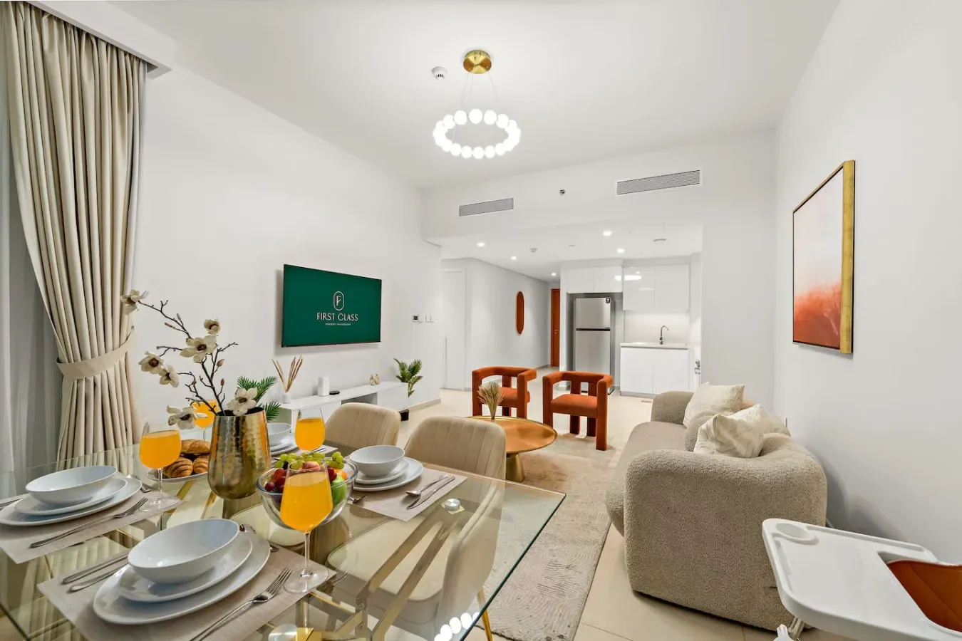 A bright living and dining area with a glass table and seating.