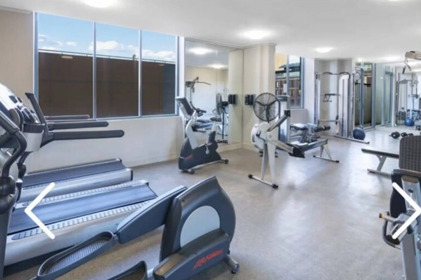 A fitness room with treadmills and exercise equipment.