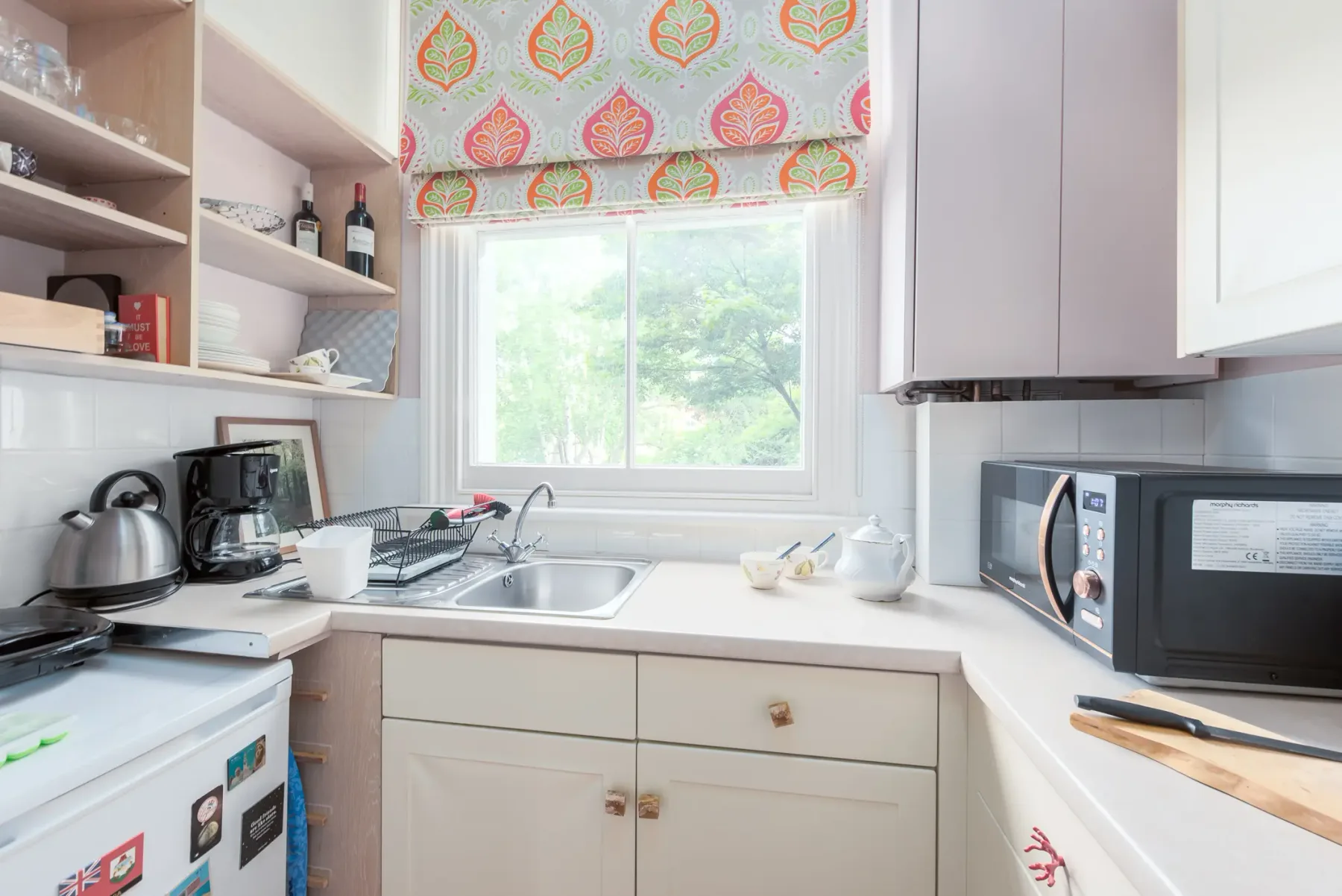A bright kitchen with a sink beneath a window.