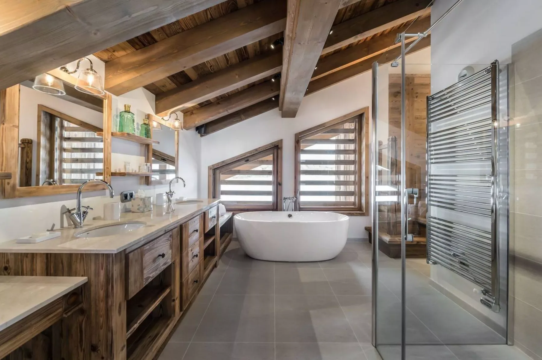 A spacious bathroom with a freestanding bathtub, vanity, and glass shower.
