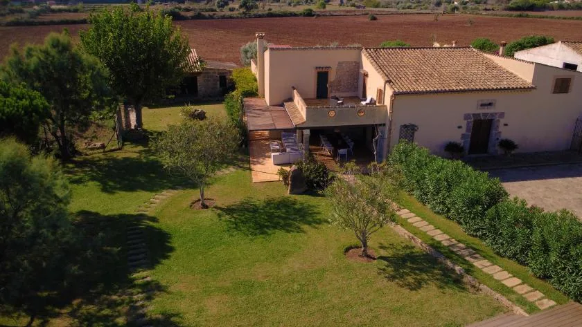 Aerial view of a house with a lawn and stepping-stone path.