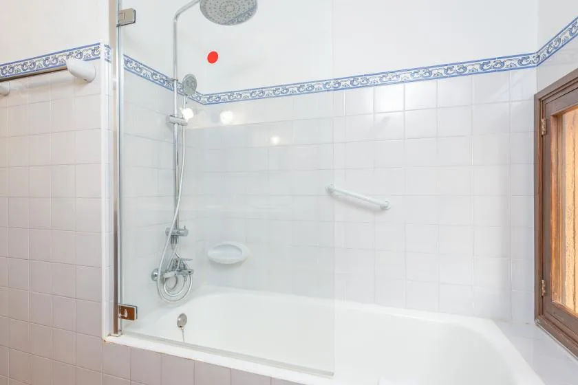 A tiled bathroom with a bathtub and shower.