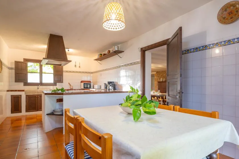 A kitchen and dining area with a table set in the foreground.