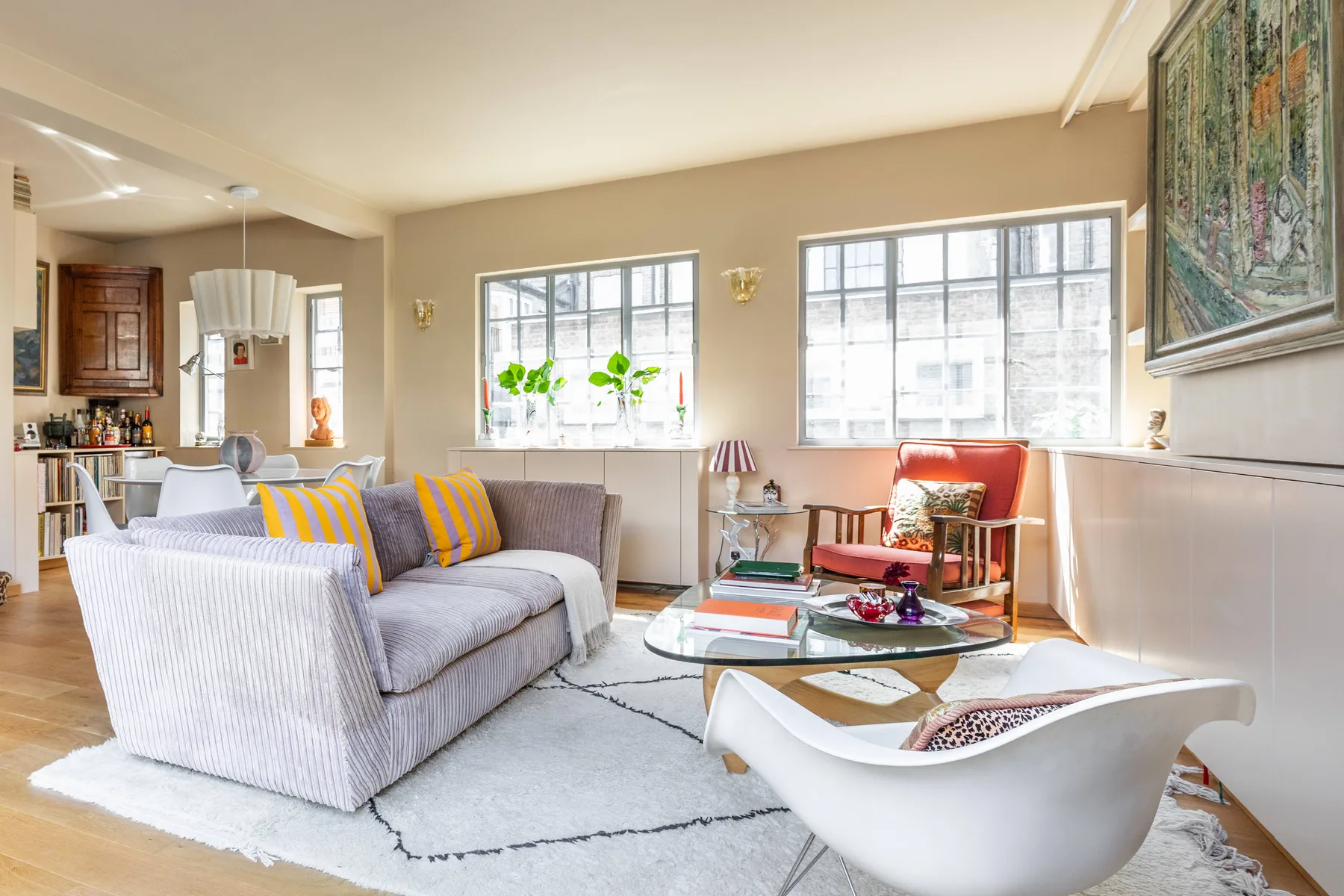 A bright living room with seating arranged around a coffee table.
