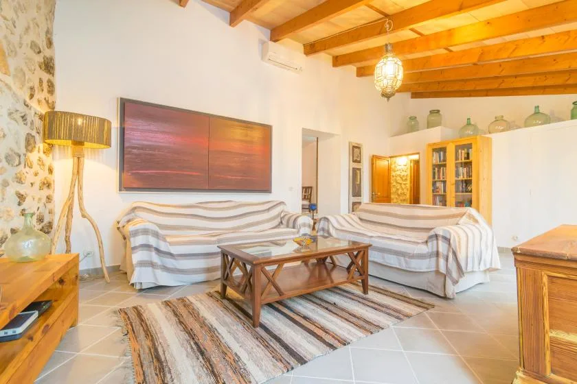 A living room with striped seating arranged around a wooden coffee table.