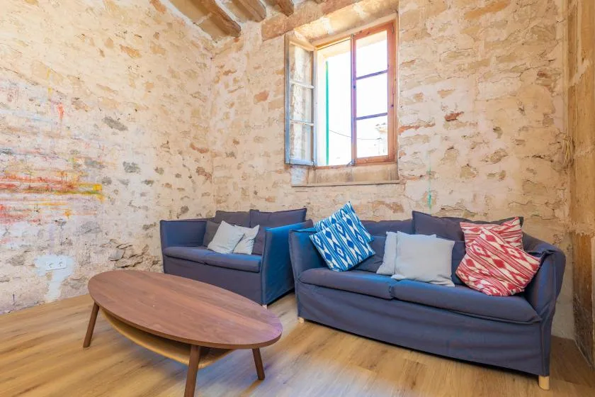 A living room with blue seating around a low wooden coffee table.