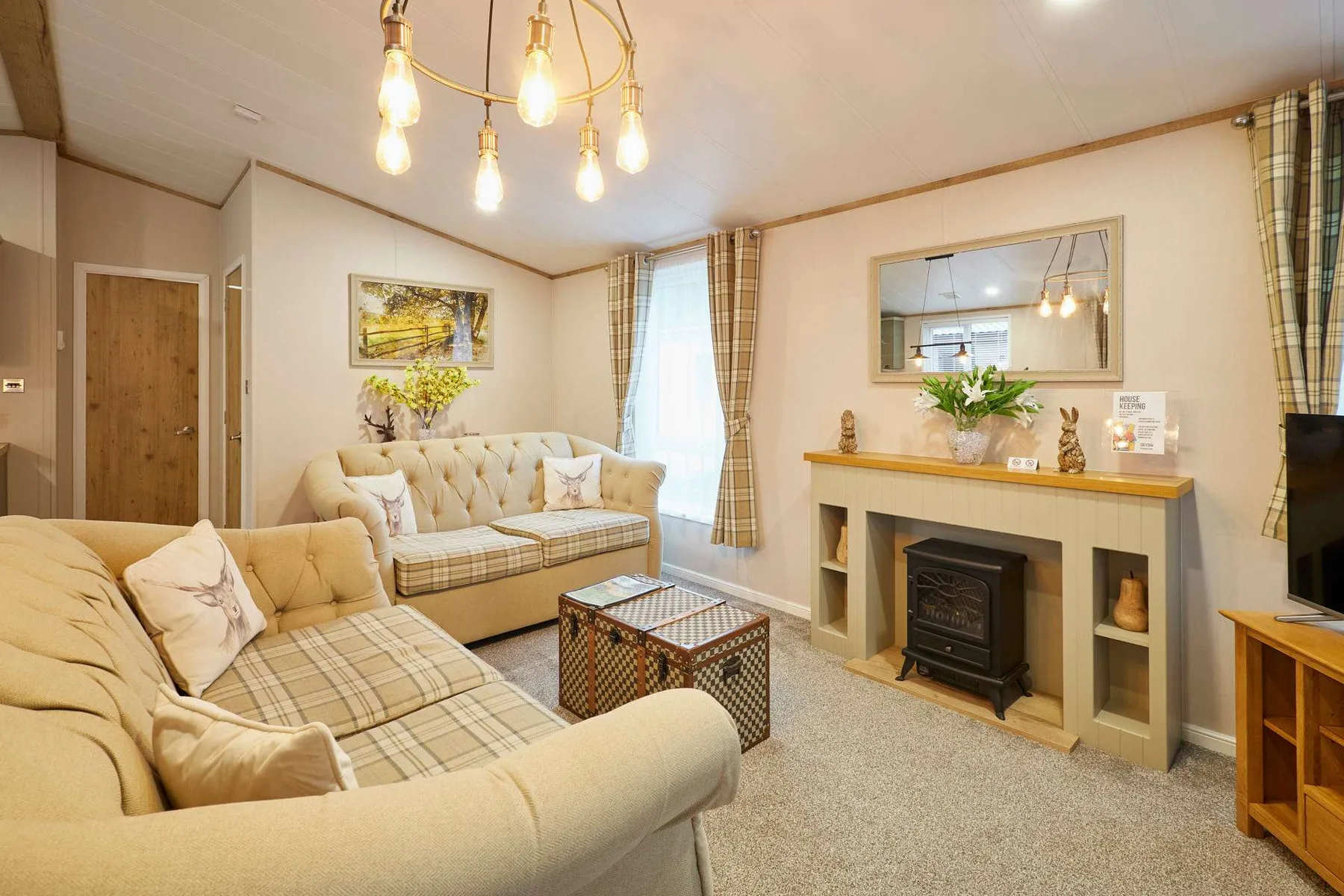 A living room with upholstered seating, a coffee table, and a fireplace.