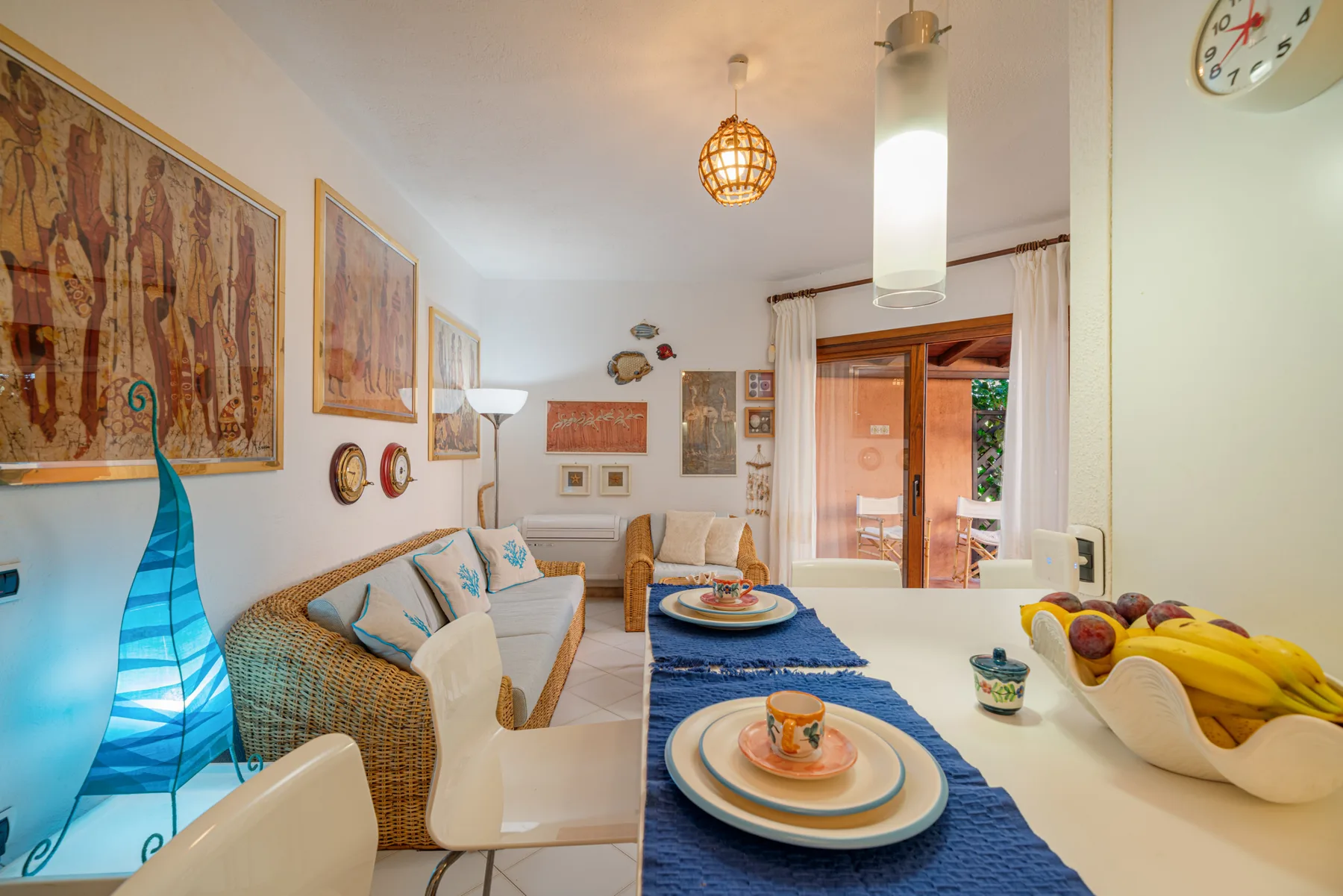 A bright dining and sitting area with a table set beside a sofa.