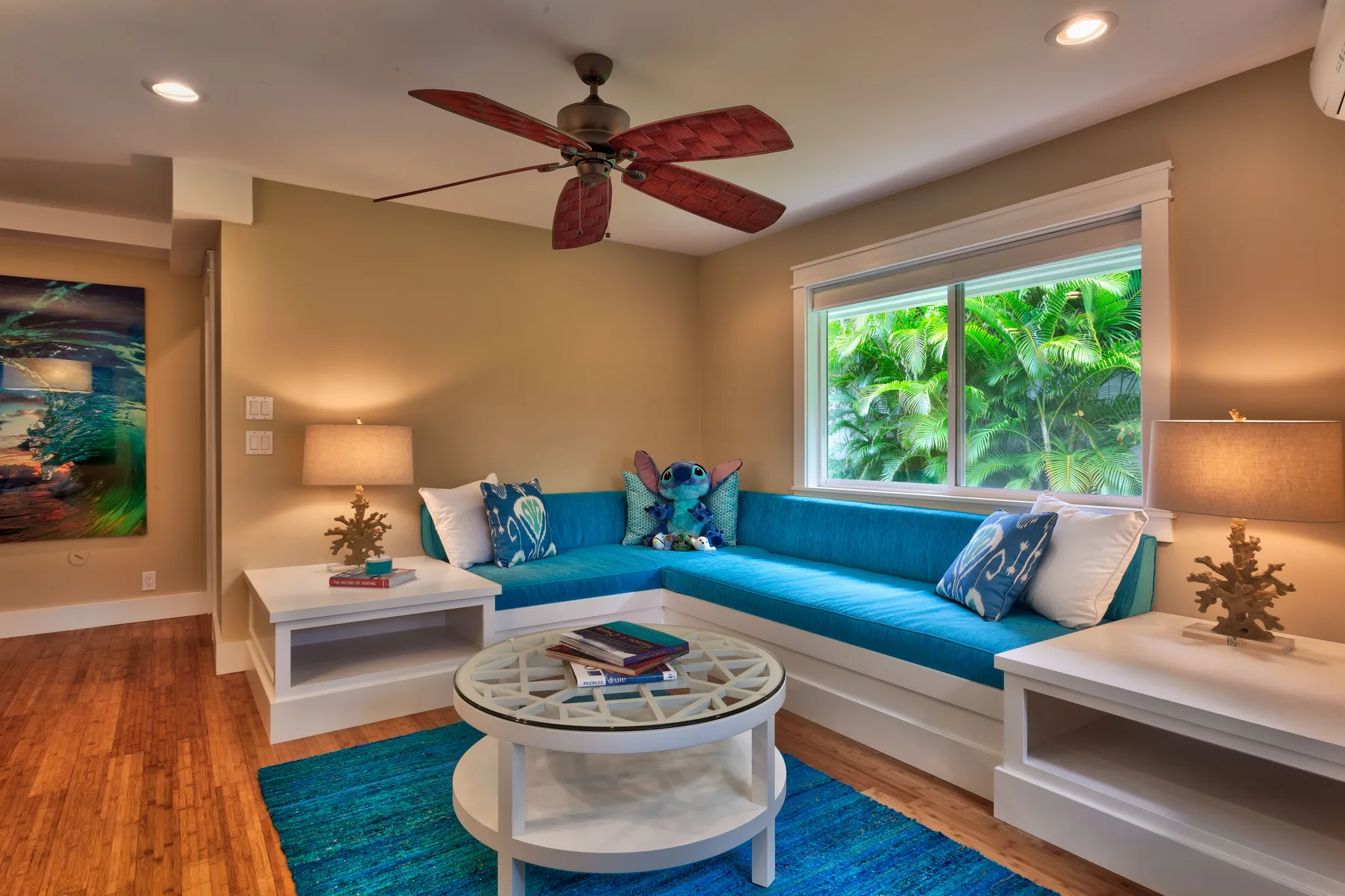 A living room with blue seating around a round coffee table.