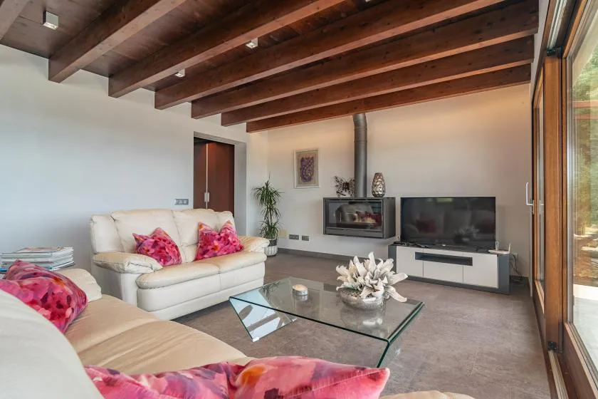 Living room with seating, a glass coffee table, and a fireplace.