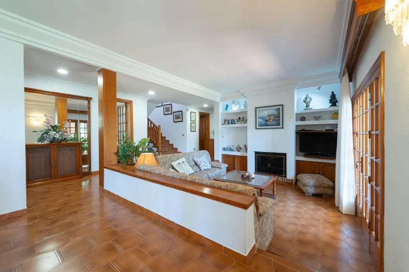 A living room with seating around a coffee table and a fireplace.
