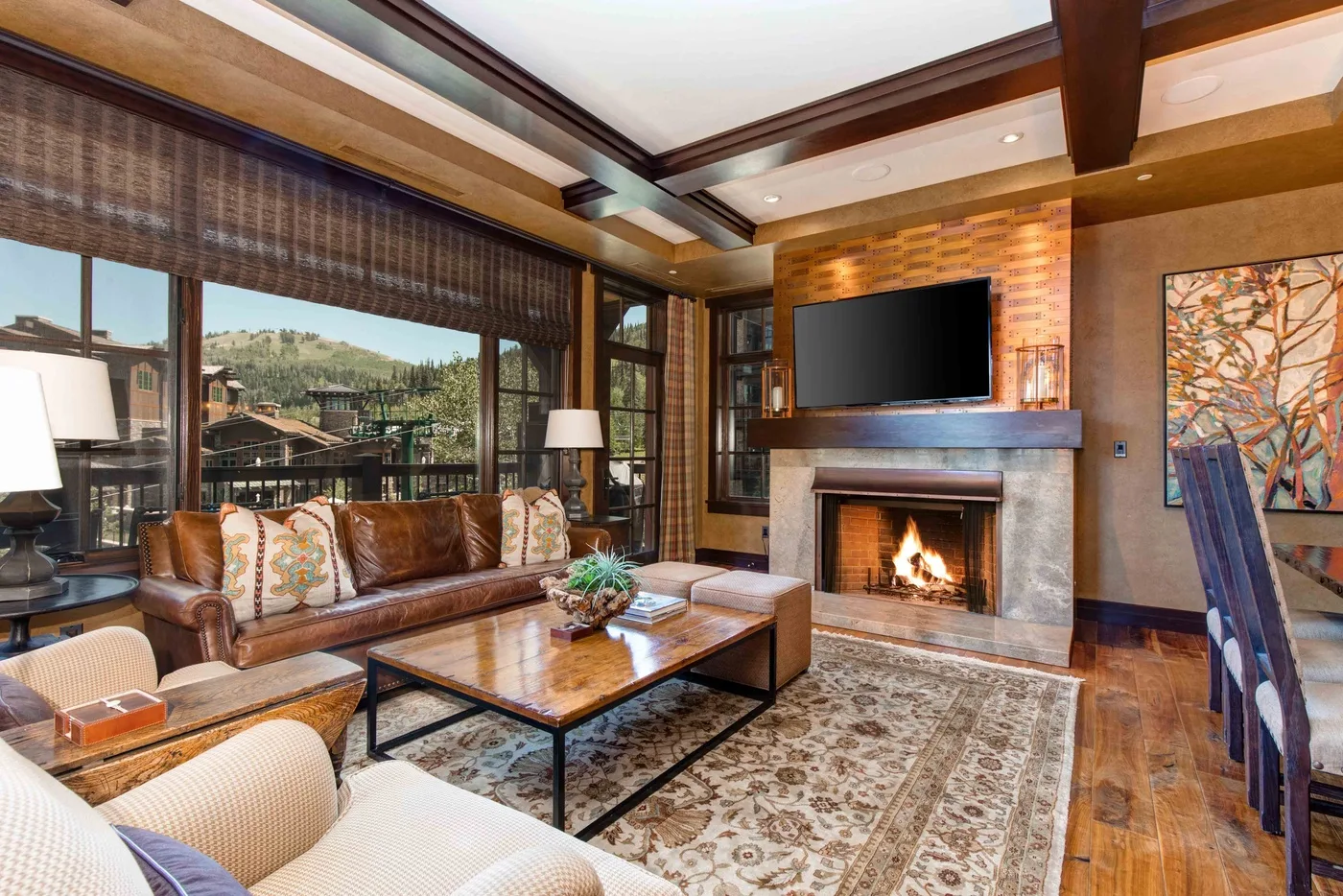 A living room with seating around a coffee table and a fireplace.