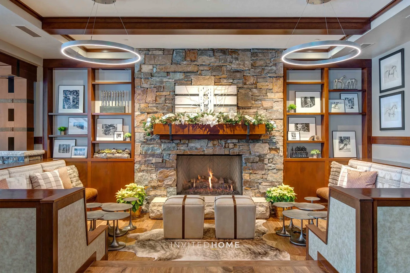 A lounge with a stone fireplace, built-in shelves, and seating.
