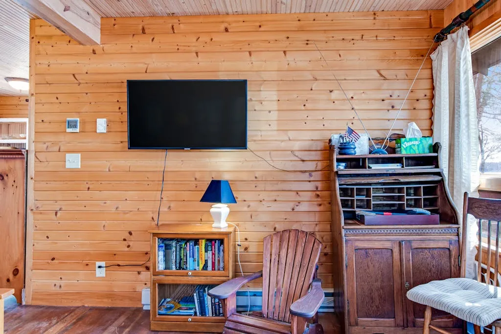 A wood-paneled living area with a television and seating.
