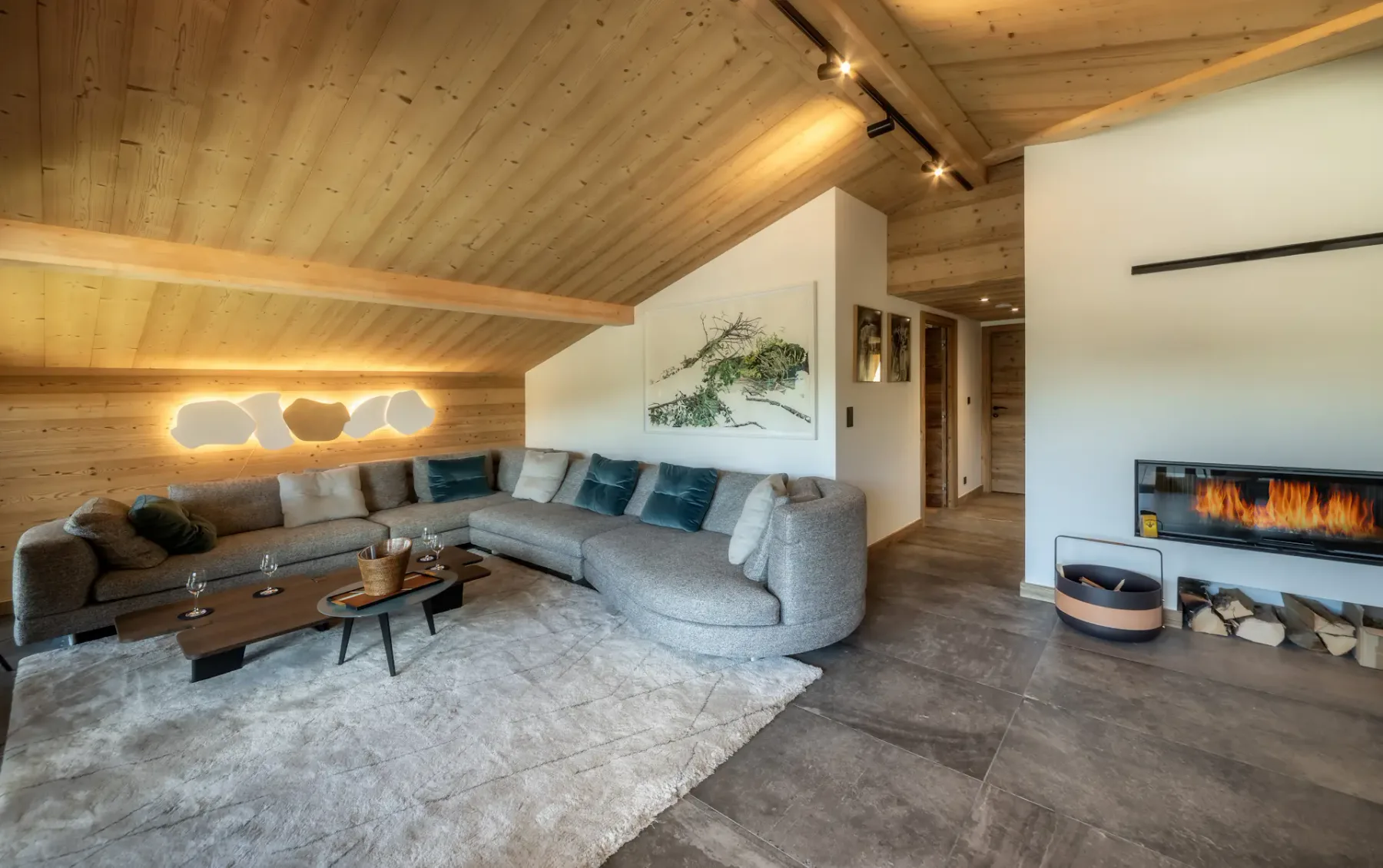 A spacious living room has sectional seating, a coffee table, and a fireplace.