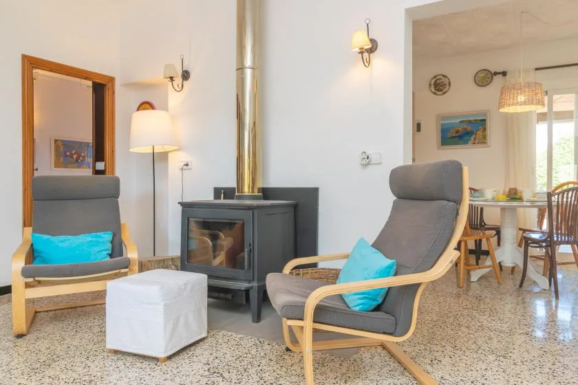 A sitting area with cushioned seating and a wood-burning stove.