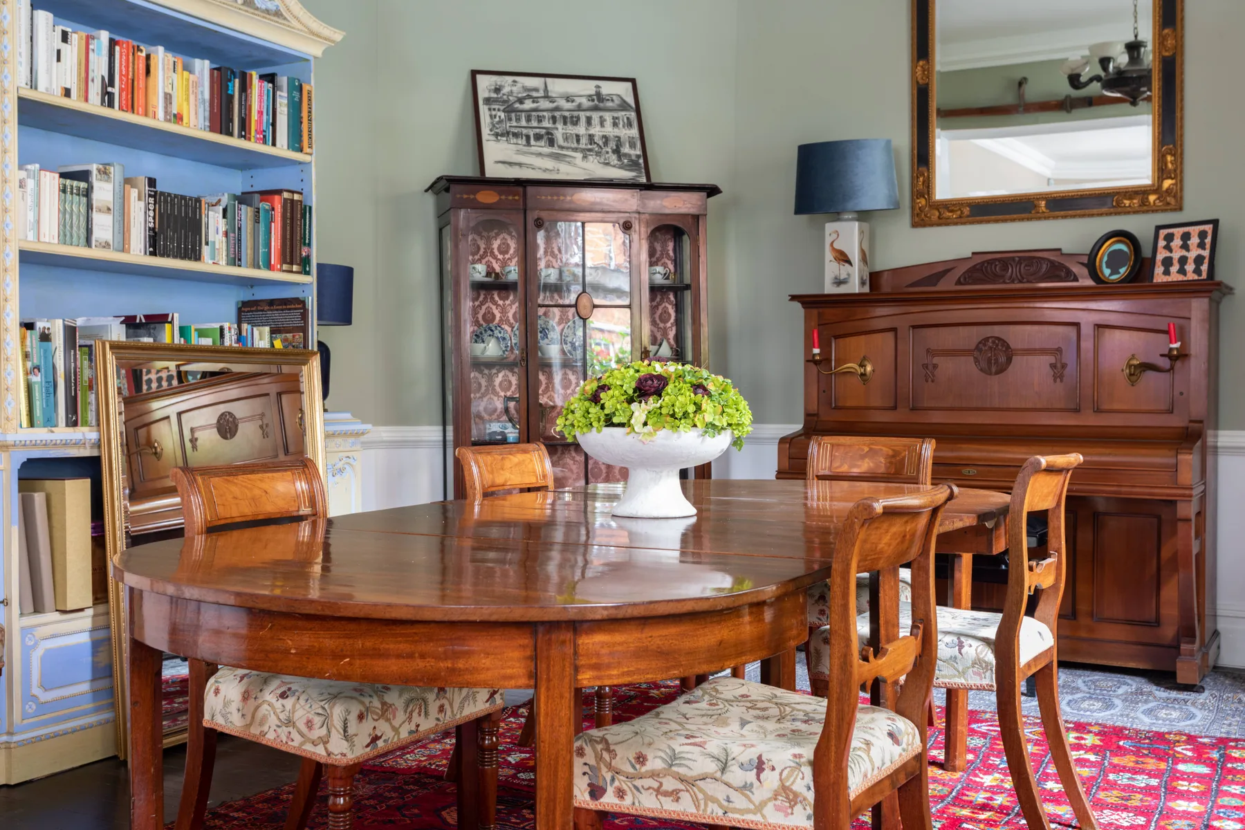 A traditional dining room with a polished wooden table and surrounding seating.