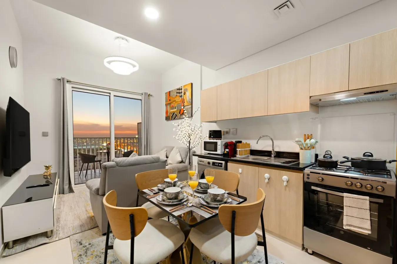 A bright open-plan kitchen and dining area with a table beside the living space.