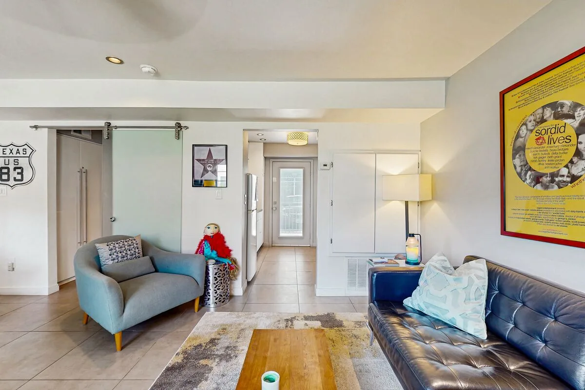 Living room with seating, a coffee table, and a glass-paneled door.